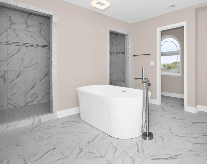 marble tile flooring in a bathroom with a freestanding tub